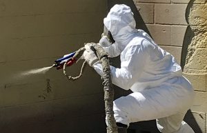 Man applying Sprayroq product on wall