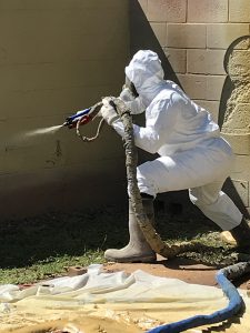 Man applying Sprayroq product on wall